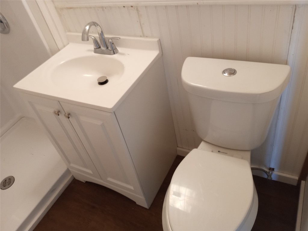 1505 Oreilly Court, Unit C Austin, TX 78734 - Photo 18 of 19 Half bathroom with vanity and wood finished floors