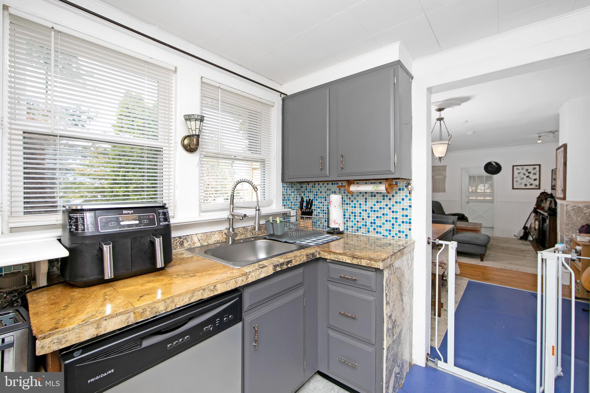 109 Rena Street Newfield, NJ 08344 - Photo 13 of 38 a kitchen with a sink stove and cabinets