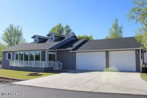 a front view of a house with yard and glass windows