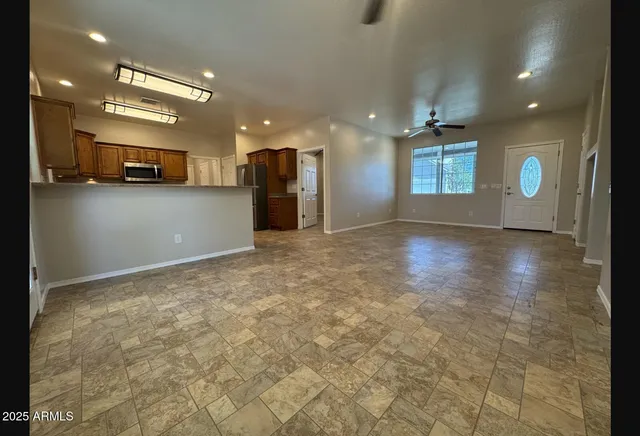 a view of a kitchen with a sink and a refrigerator in it