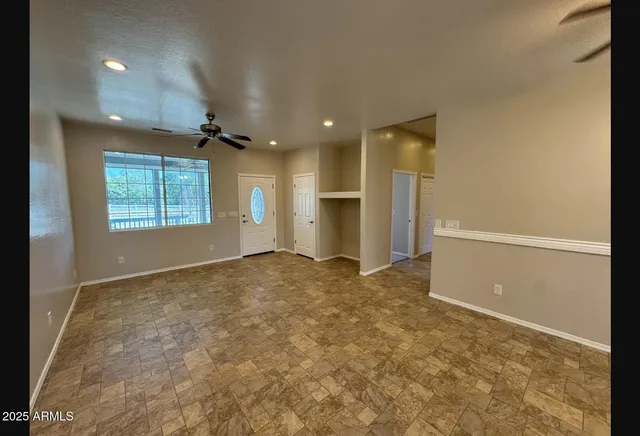 an empty room with a empty space and windows