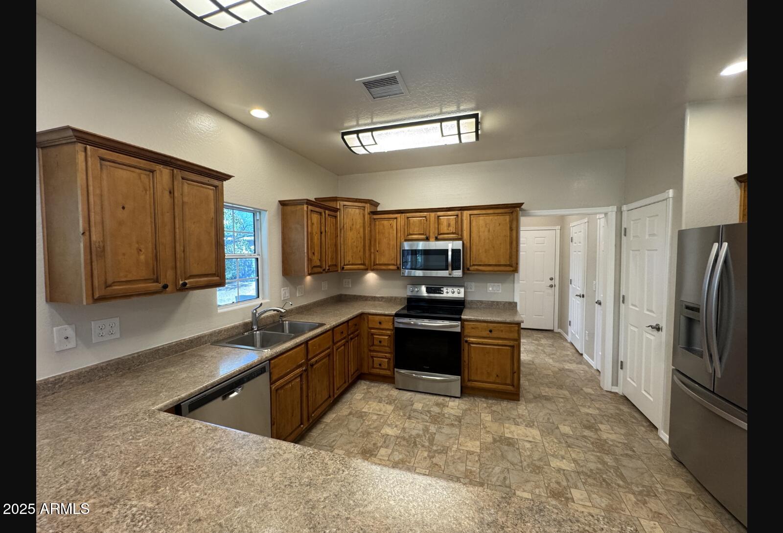 505 Raysun Lane Camp Verde, AZ 86322 - Photo 16 of 50 a kitchen with stainless steel appliances granite countertop a refrigerator and a sink