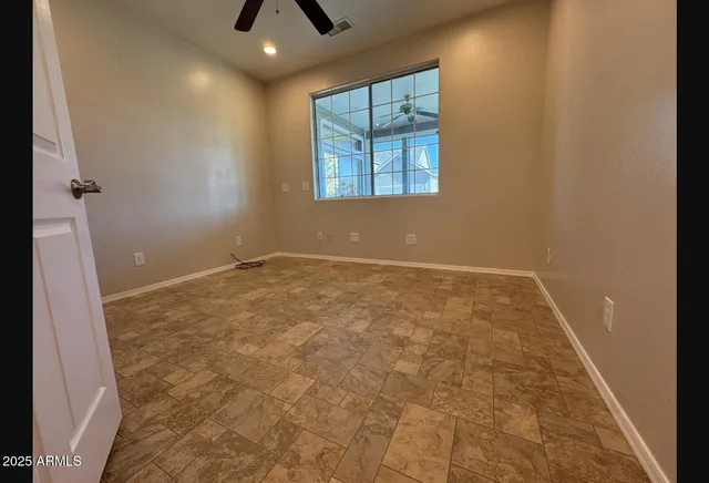 an empty room with windows and entrance