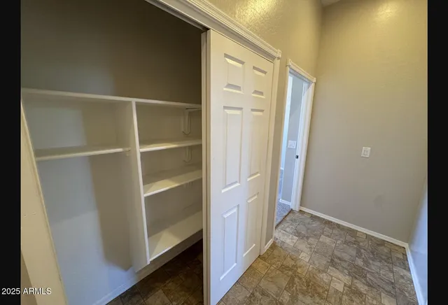 a bathroom with a granite countertop toilet sink and mirror