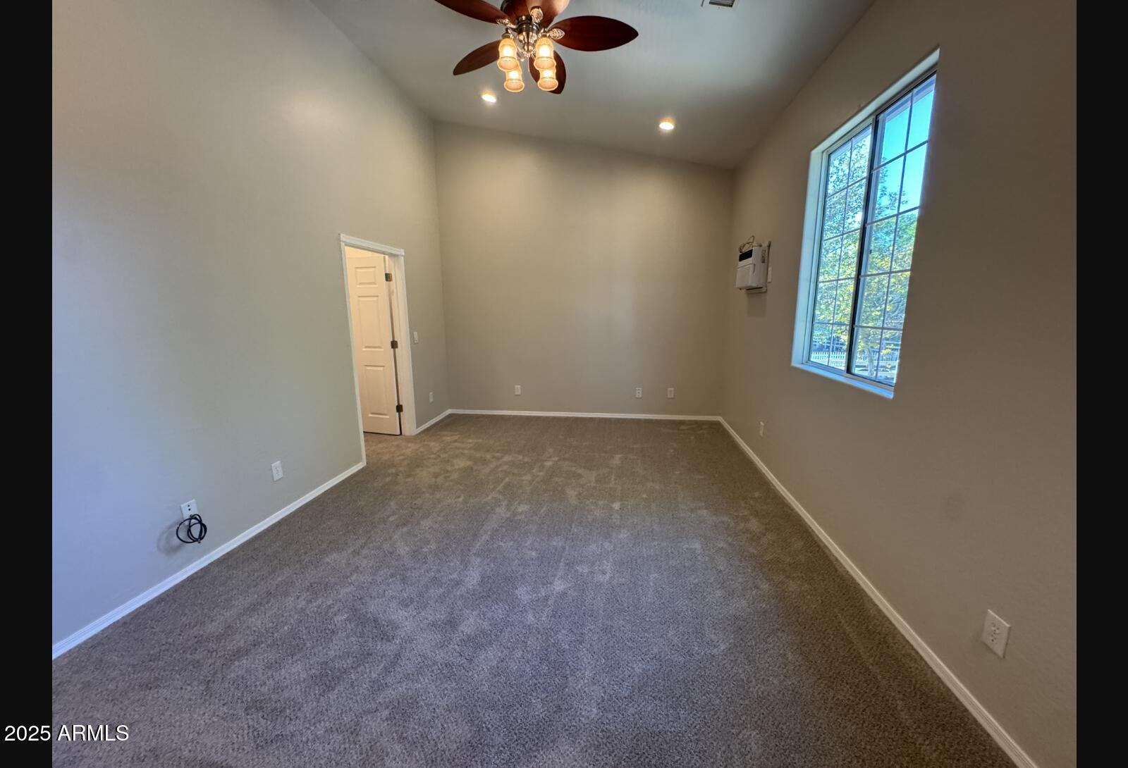505 Raysun Lane Camp Verde, AZ 86322 - Photo 37 of 50 an empty room with a window and ceiling fan