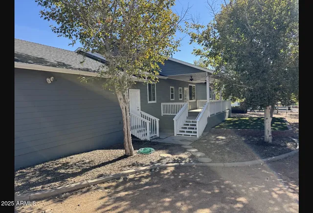 a view of a house with a yard and tree s