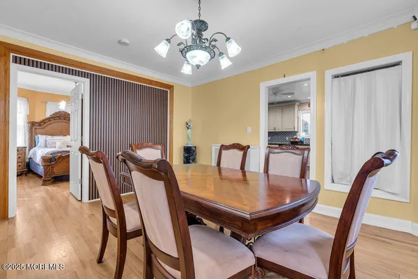 a view of a dining room with furniture and a chandelier