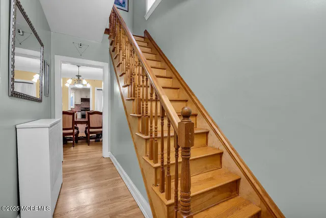 a view of staircase with railing and white walls