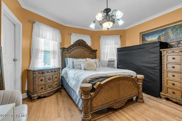 a bedroom with a bed dresser and a window