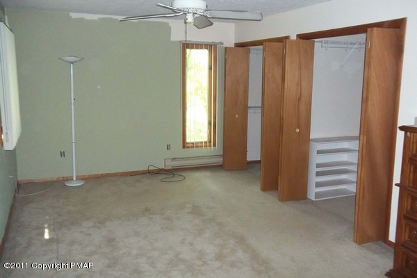 2721-19 Radcliff Road Bushkill, PA 18324 - Photo 3 of 19 an empty room with windows and chandelier fan