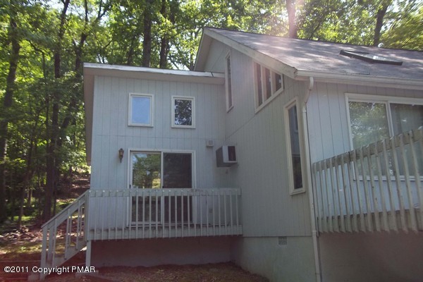 2721-19 Radcliff Road Bushkill, PA 18324 - Photo 6 of 19 a side view of a house with a porch