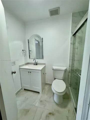 a bathroom with a toilet sink and a mirror