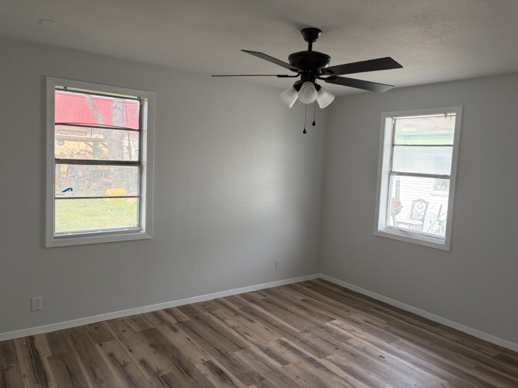 604 West 4th Street Taylor, TX 76574 - Photo 7 of 8 Unfurnished room with dark wood finished floors and a ceiling fan