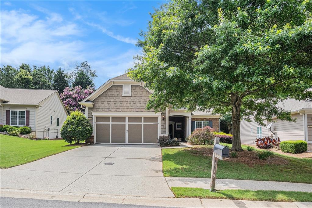 4445 Vanadium Bend Cumming, GA 30040 - Photo 1 of 1 a front view of a house with a yard and potted plants