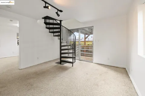wooden floor in an empty room with a staircase