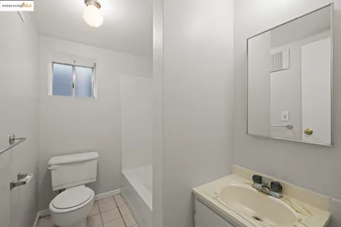 a bathroom with a sink a toilet and mirror