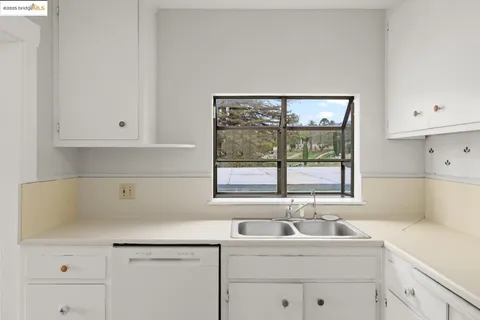 a kitchen with a sink and cabinets