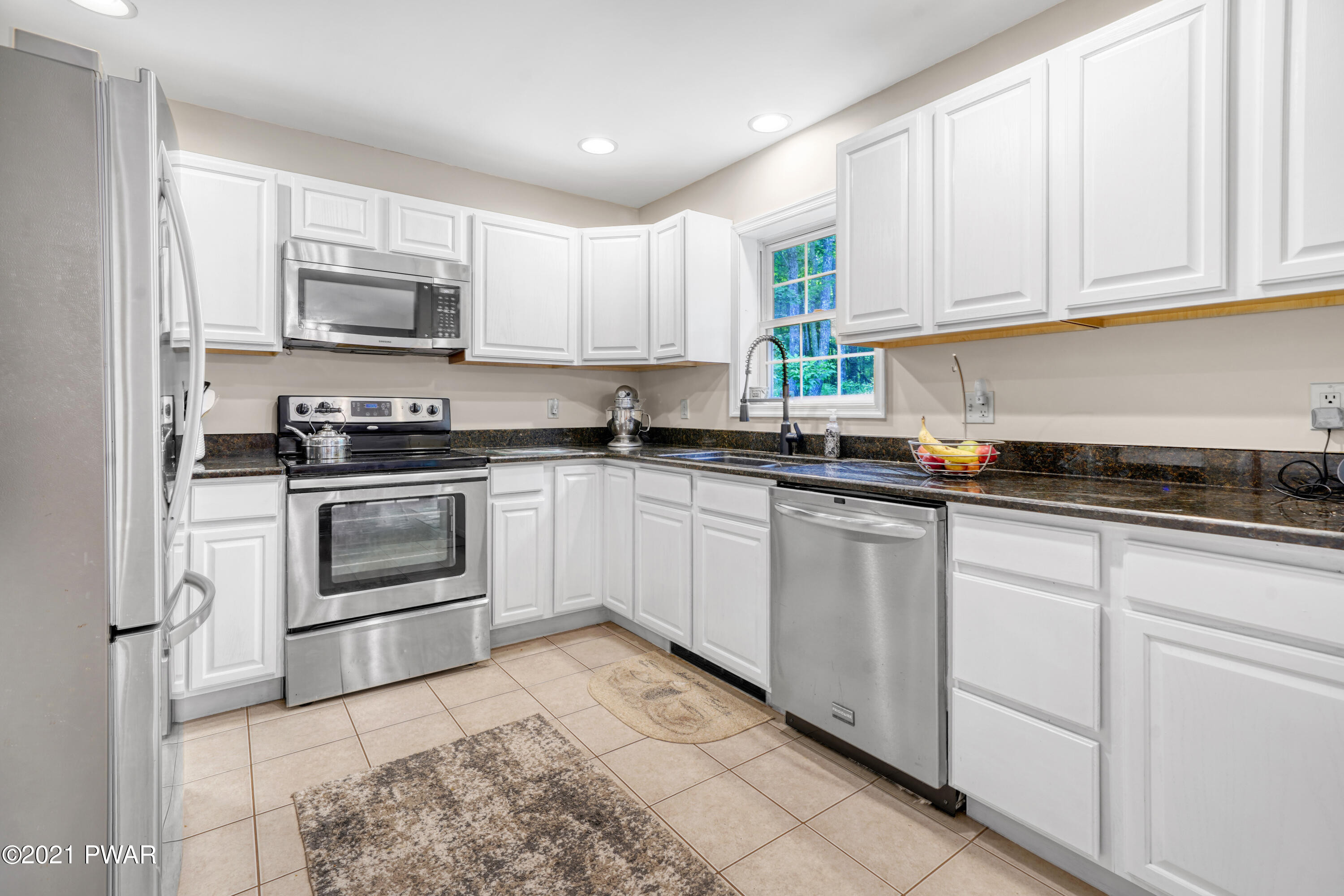 125 Forest Road Dingmans Ferry, PA 18328 - Photo 16 of 28 a kitchen with white cabinets stainless steel appliances and sink