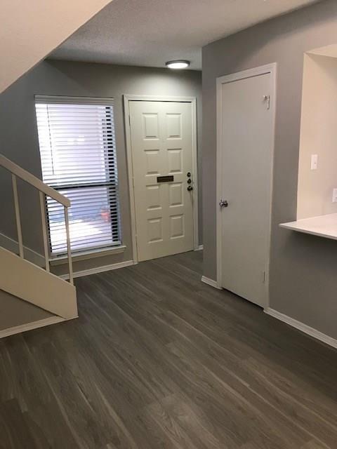 18240 Midway Road, Unit 303 Dallas, TX 75287 - Photo 21 of 22 Foyer with dark wood-type flooring and baseboards