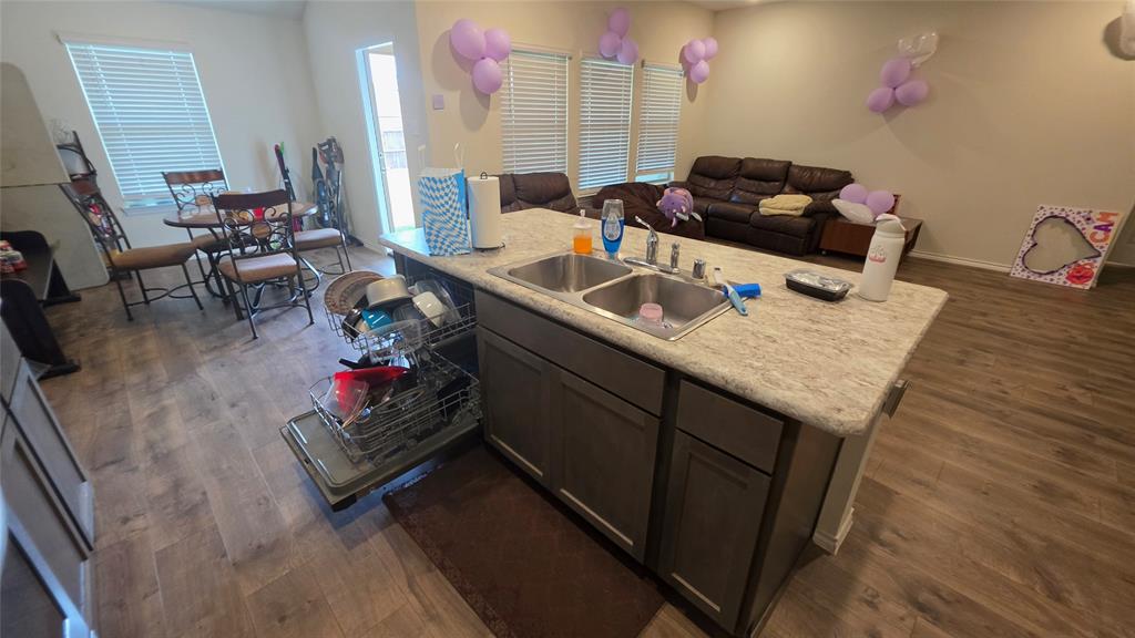 409 Samuel Street Denton, TX 76207 - Photo 23 of 40 a living room with furniture and a wooden floor
