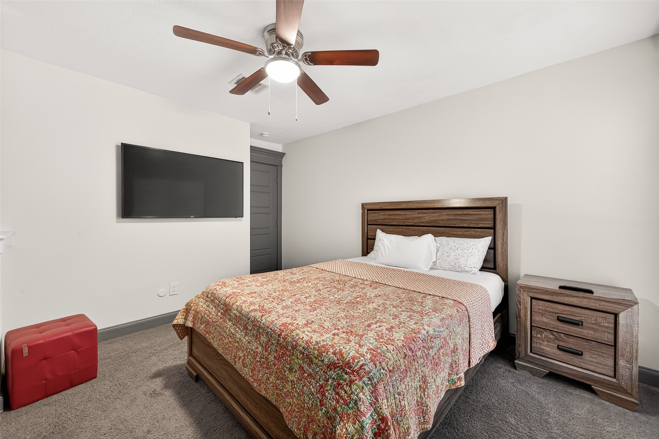 3684 Ocee Street Houston, TX 77063 - Photo 22 of 32 a bedroom with a bed and a flat tv screen on a dresser