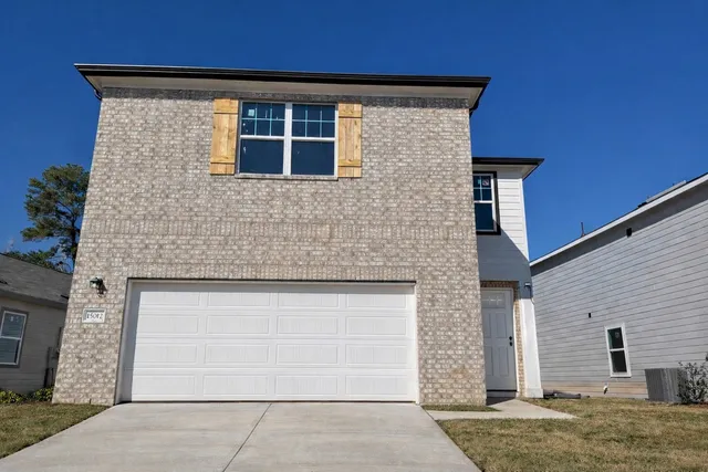 a front view of a house with garage