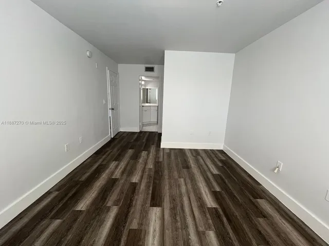 a view of room with wooden floor