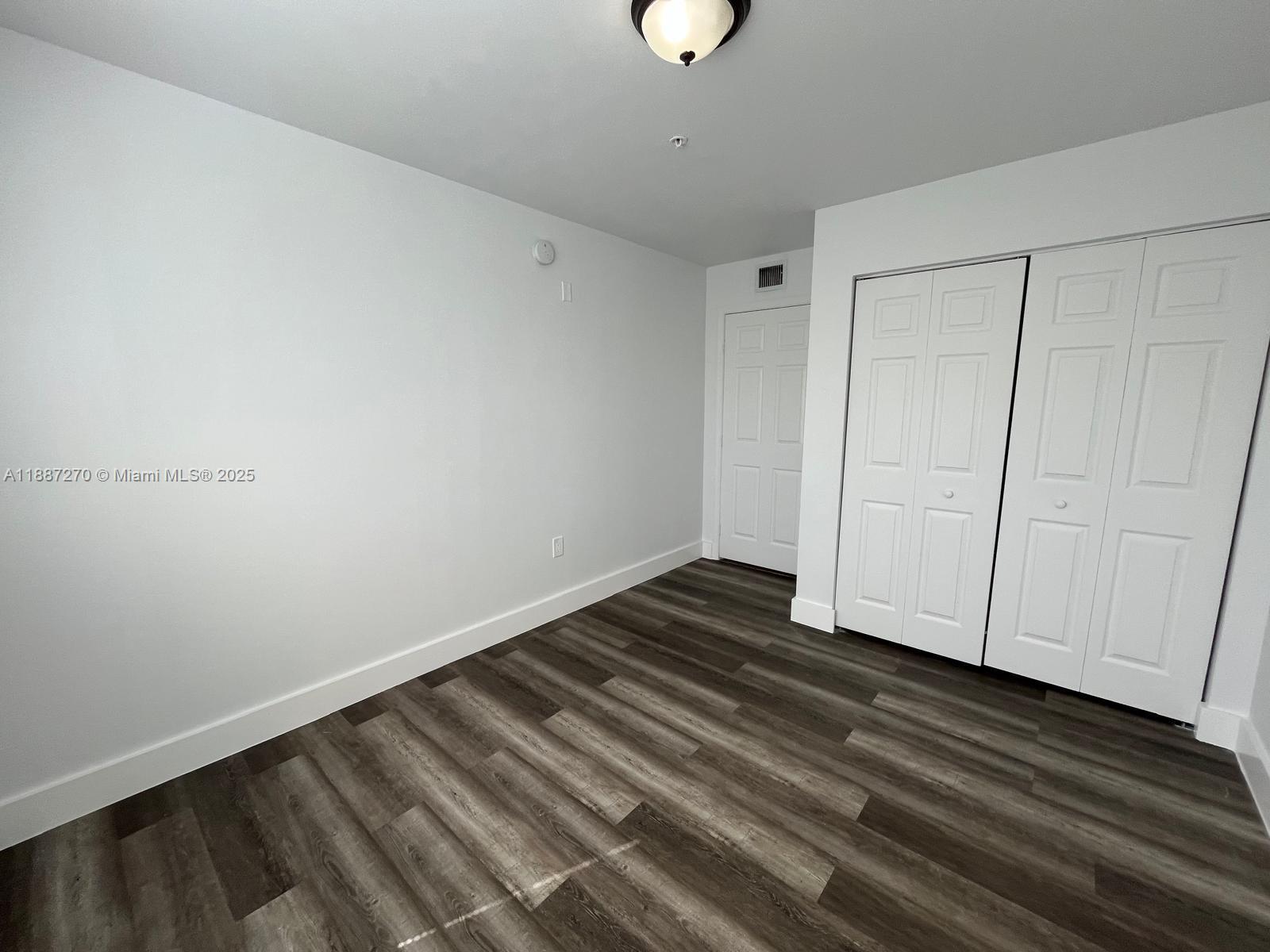655 Southwest 111th Way, Unit 308 Pembroke Pines, FL 33025 - Photo 14 of 42 a view of room with wooden floor
