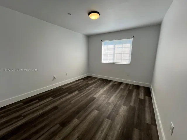 a view of room with wooden floor