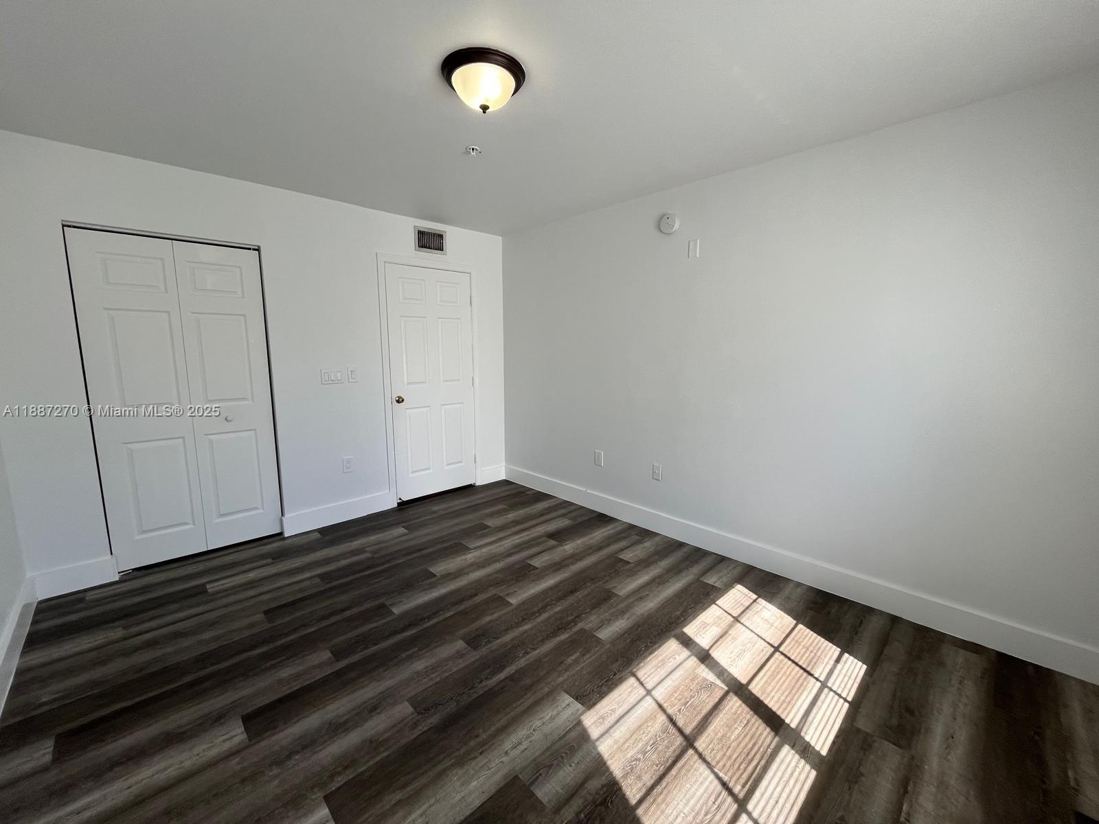 655 Southwest 111th Way, Unit 308 Pembroke Pines, FL 33025 - Photo 18 of 42 a view of an empty room and wooden floor