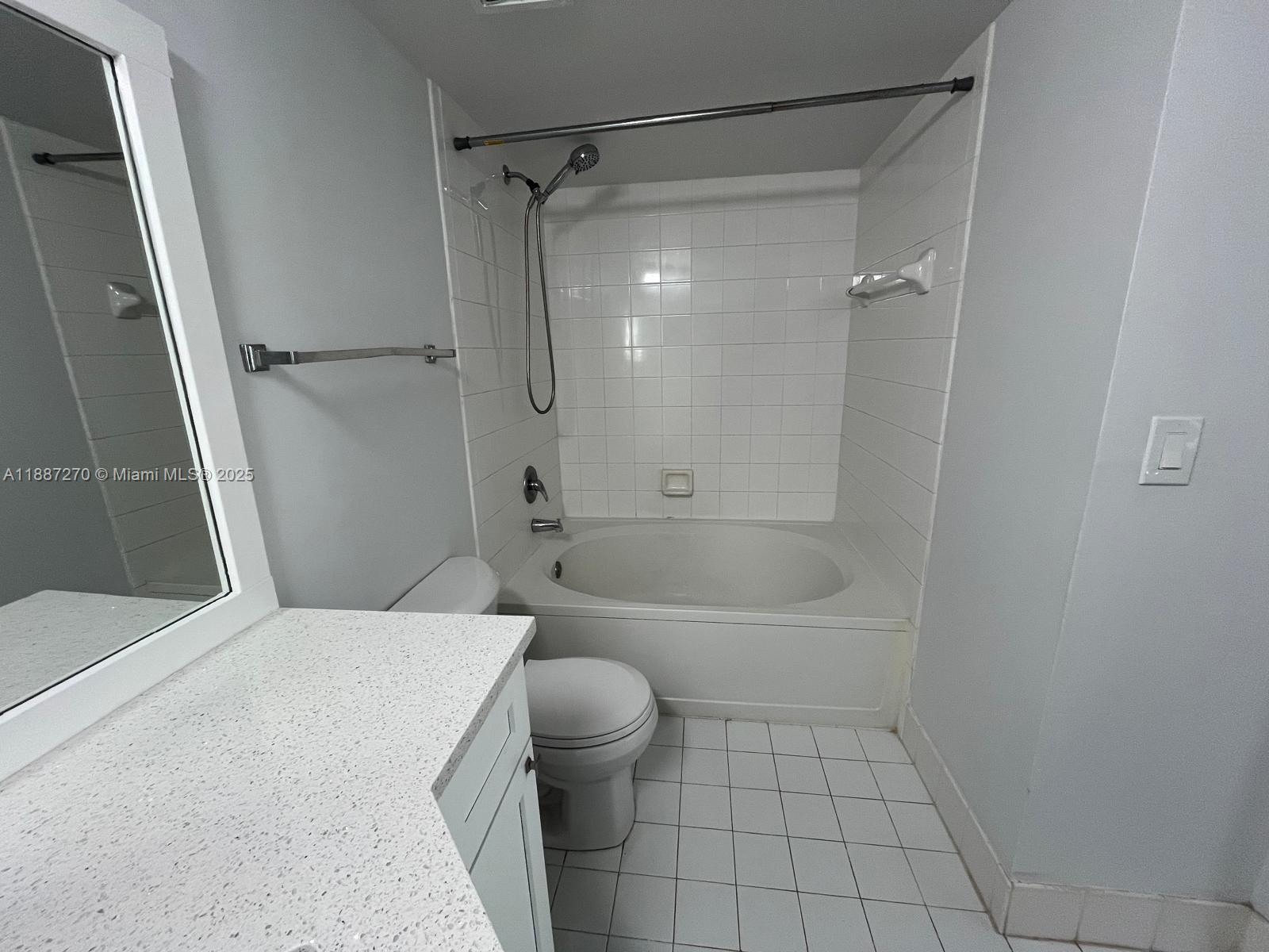 655 Southwest 111th Way, Unit 308 Pembroke Pines, FL 33025 - Photo 22 of 42 a bathroom with a bathtub shower and toilet