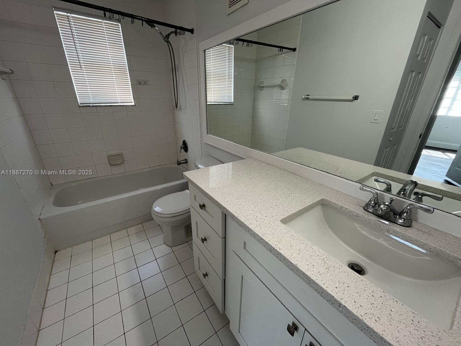 655 Southwest 111th Way, Unit 308 Pembroke Pines, FL 33025 - Photo 23 of 42 a bathroom with a sink a toilet and shower