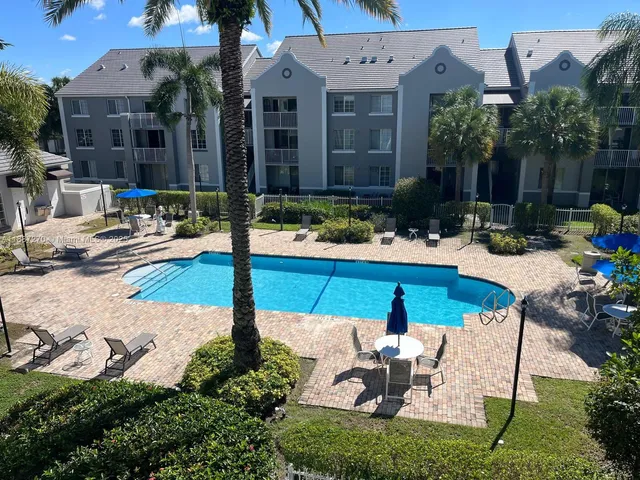 a view of a patio with chairs and plants