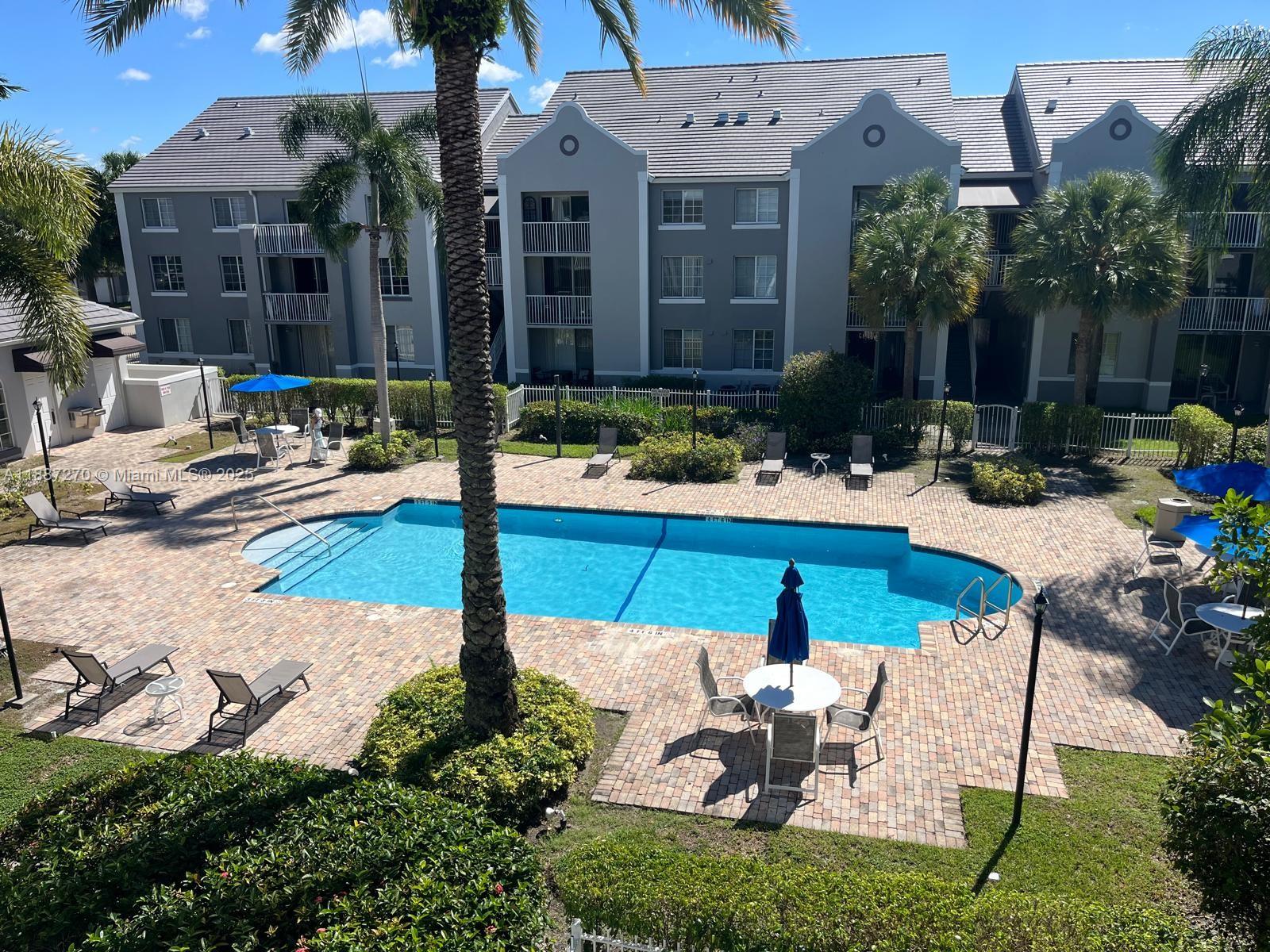 655 Southwest 111th Way, Unit 308 Pembroke Pines, FL 33025 - Photo 31 of 42 a view of a patio with chairs and plants