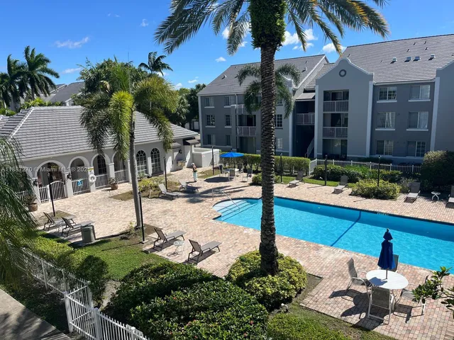 a front view of a house with garden and swimming pool