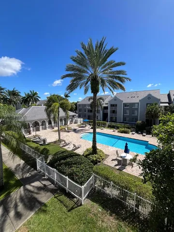 a view of a swimming pool with a patio and a yard