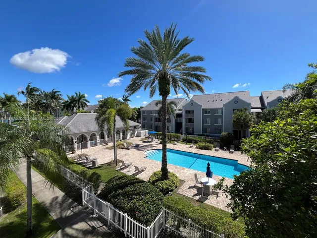 a view of a house with swimming pool patio and outdoor kitchen