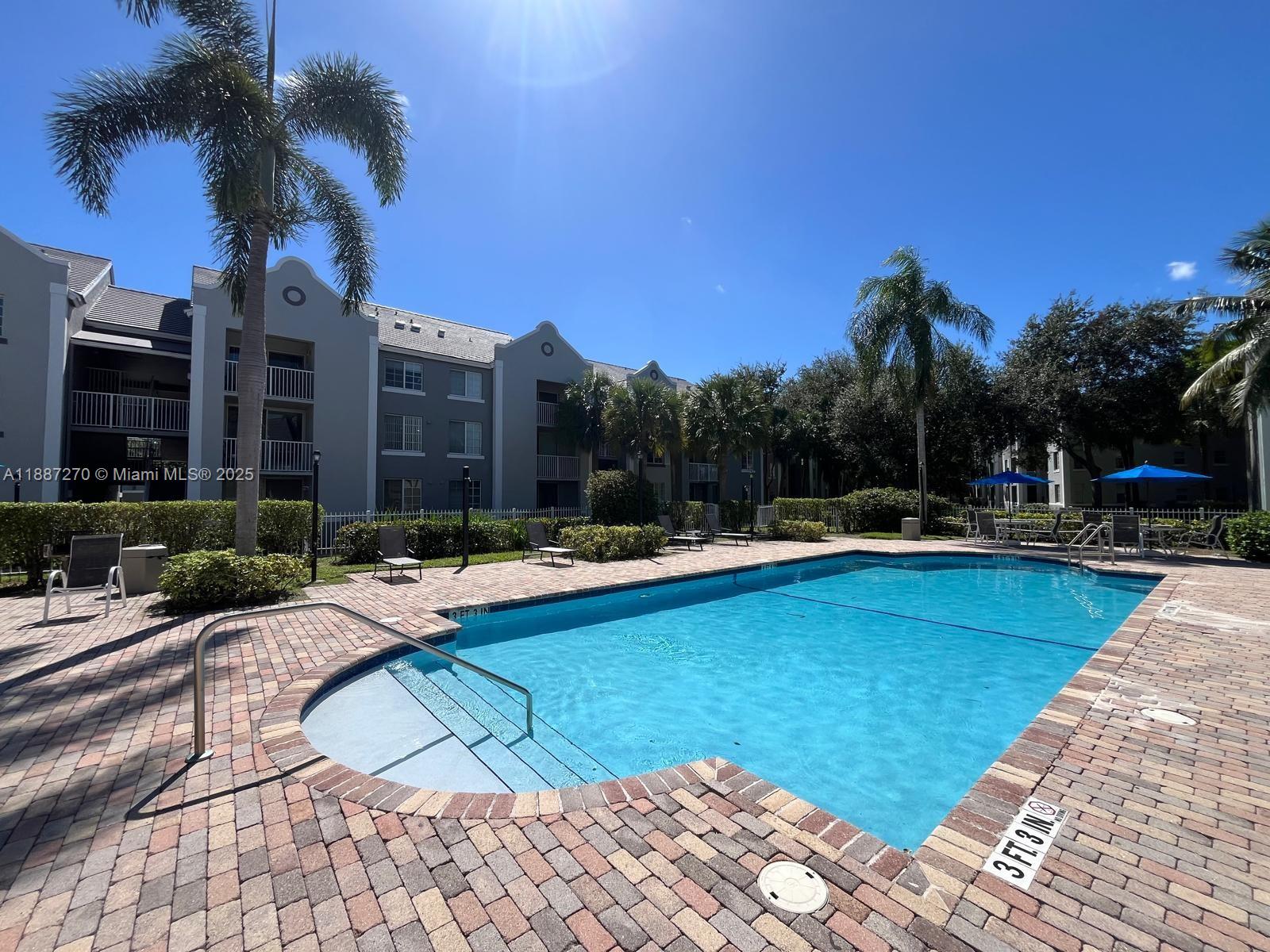 655 Southwest 111th Way, Unit 308 Pembroke Pines, FL 33025 - Photo 35 of 42 a view of swimming pool and lounge chair