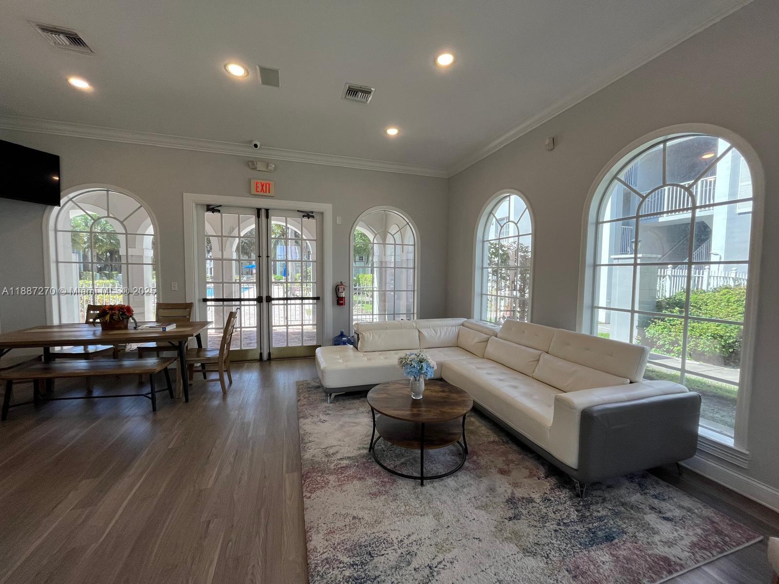 655 Southwest 111th Way, Unit 308 Pembroke Pines, FL 33025 - Photo 38 of 42 a living room with furniture and a large window