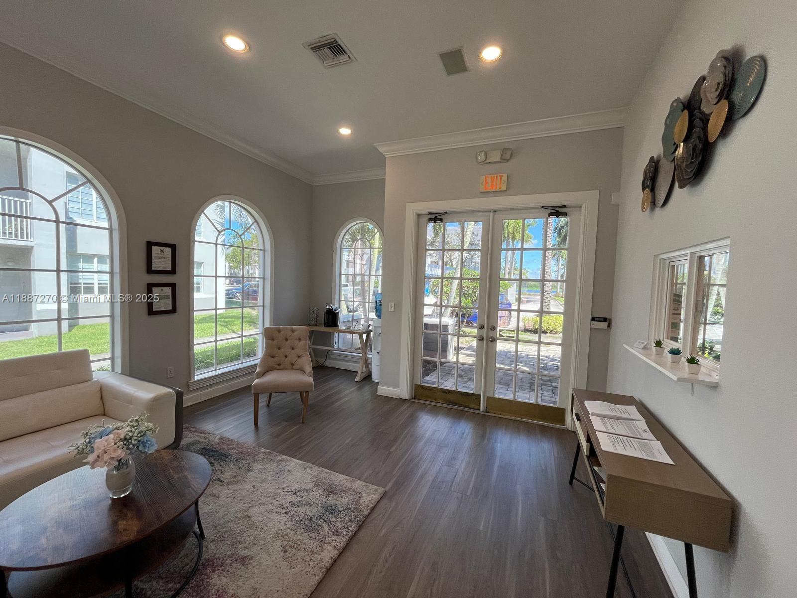 655 Southwest 111th Way, Unit 308 Pembroke Pines, FL 33025 - Photo 39 of 42 a living room with furniture and a wooden floor