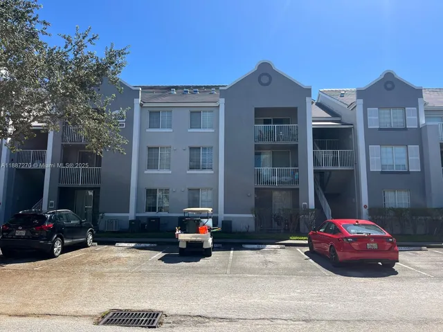 a front view of a house with parking space