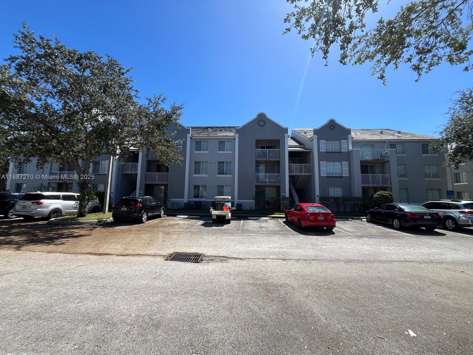 655 Southwest 111th Way, Unit 308 Pembroke Pines, FL 33025 - Photo 41 of 42 a view of a parked cars in front of a building