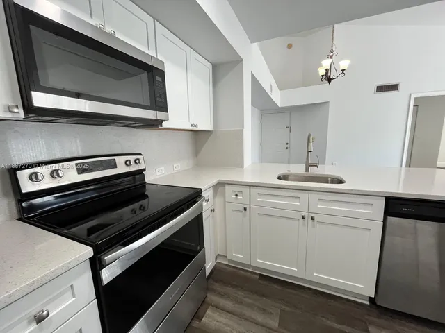 a kitchen with a stove microwave and sink