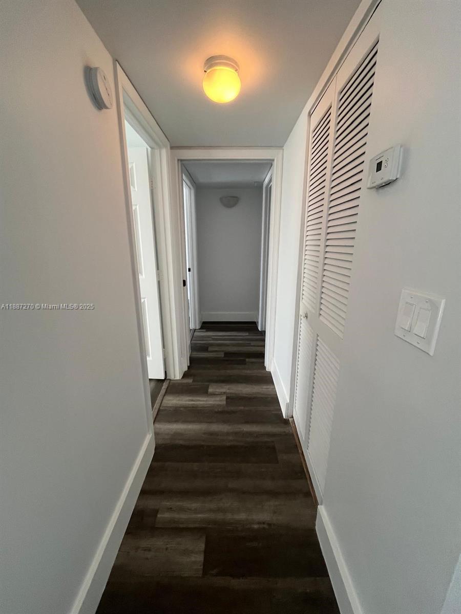 655 Southwest 111th Way, Unit 308 Pembroke Pines, FL 33025 - Photo 10 of 42 a view of a hallway with wooden floor and entryway