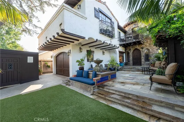 a view of a patio with a table and chairs and potted plants
