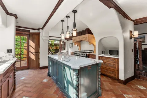 a bathroom with a granite countertop toilet sink and mirror
