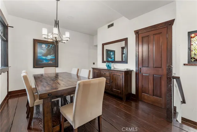 a view of a patio with table and chairs with wooden floor and plants