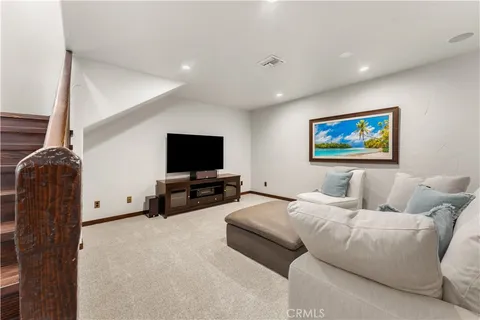 a bathroom with a granite countertop sink a mirror and shower