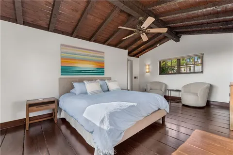 a view of backyard with a table and chairs and potted plants
