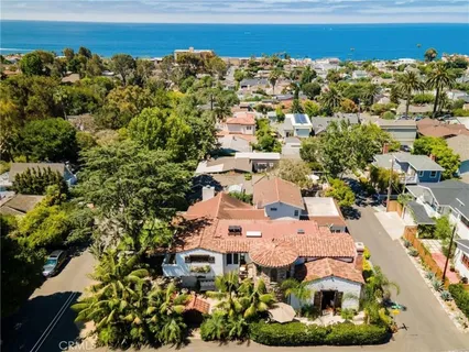a view of backyard with a table and chairs